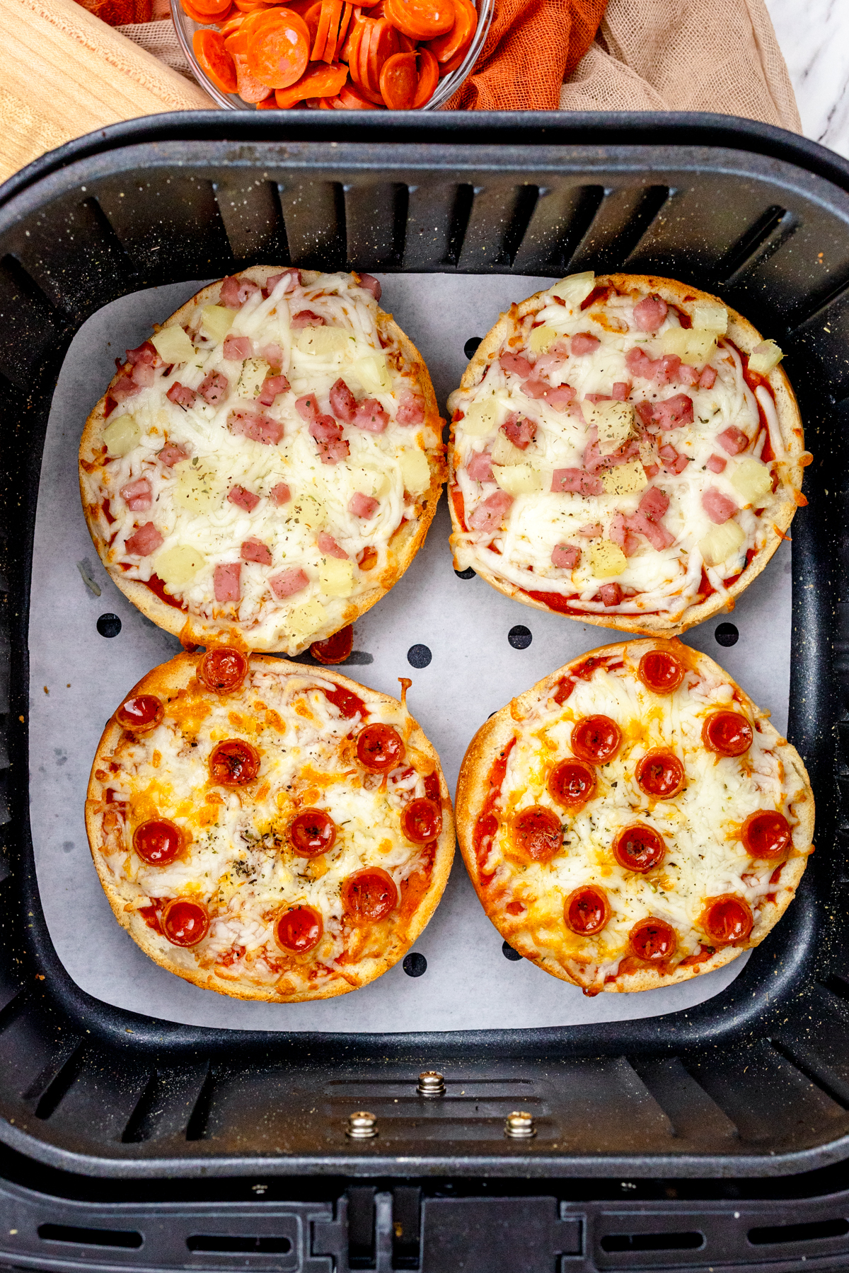 Top view of fried Air Fryer Pizza Bagels in an air fryer.