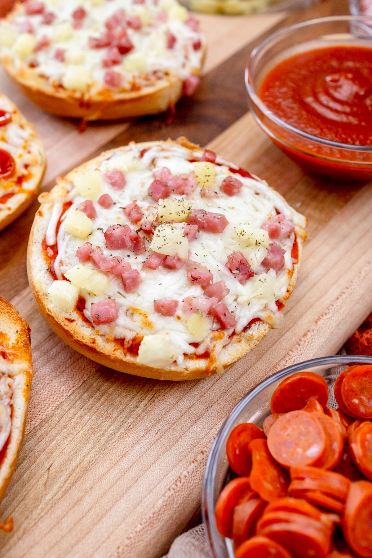 Close up view of Air Fryer Pizza Bagels on a wooden surface.