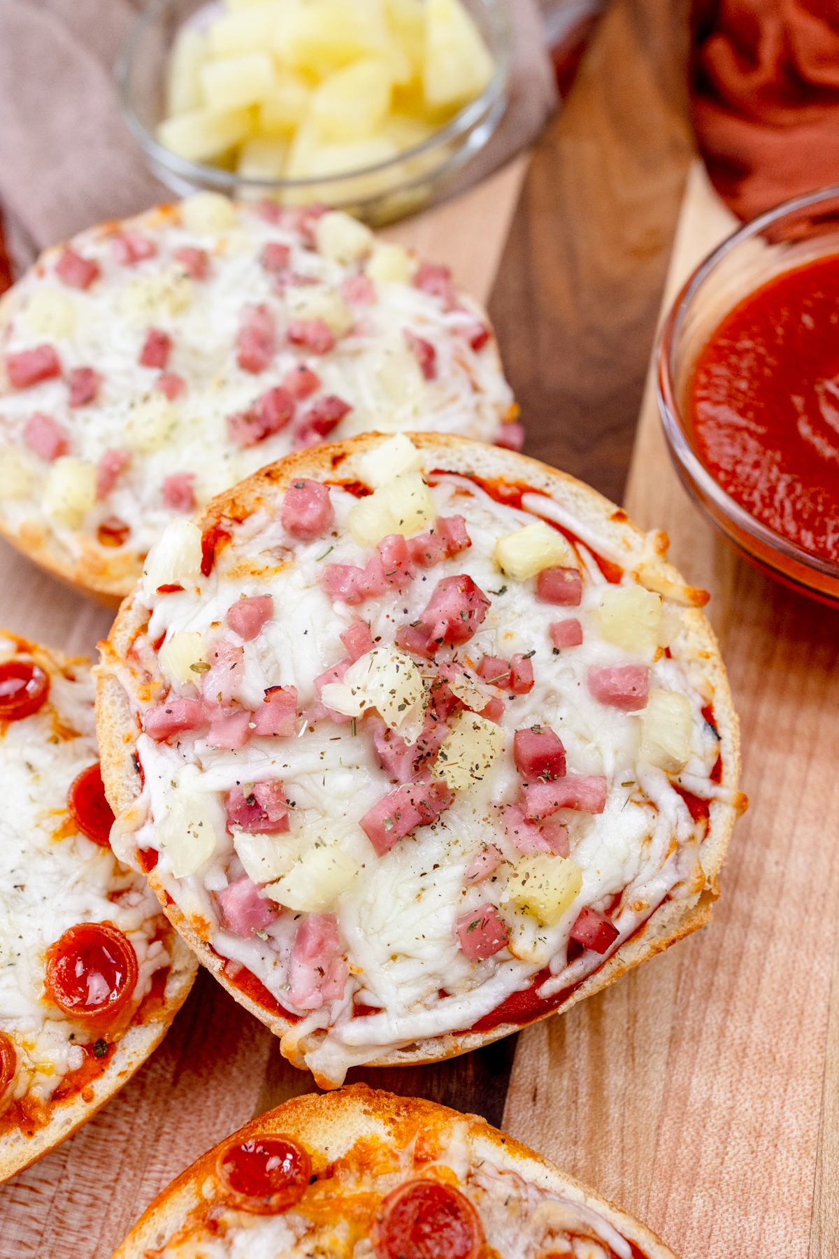 Close up view of Air Fryer Pizza Bagels on a wooden surface.