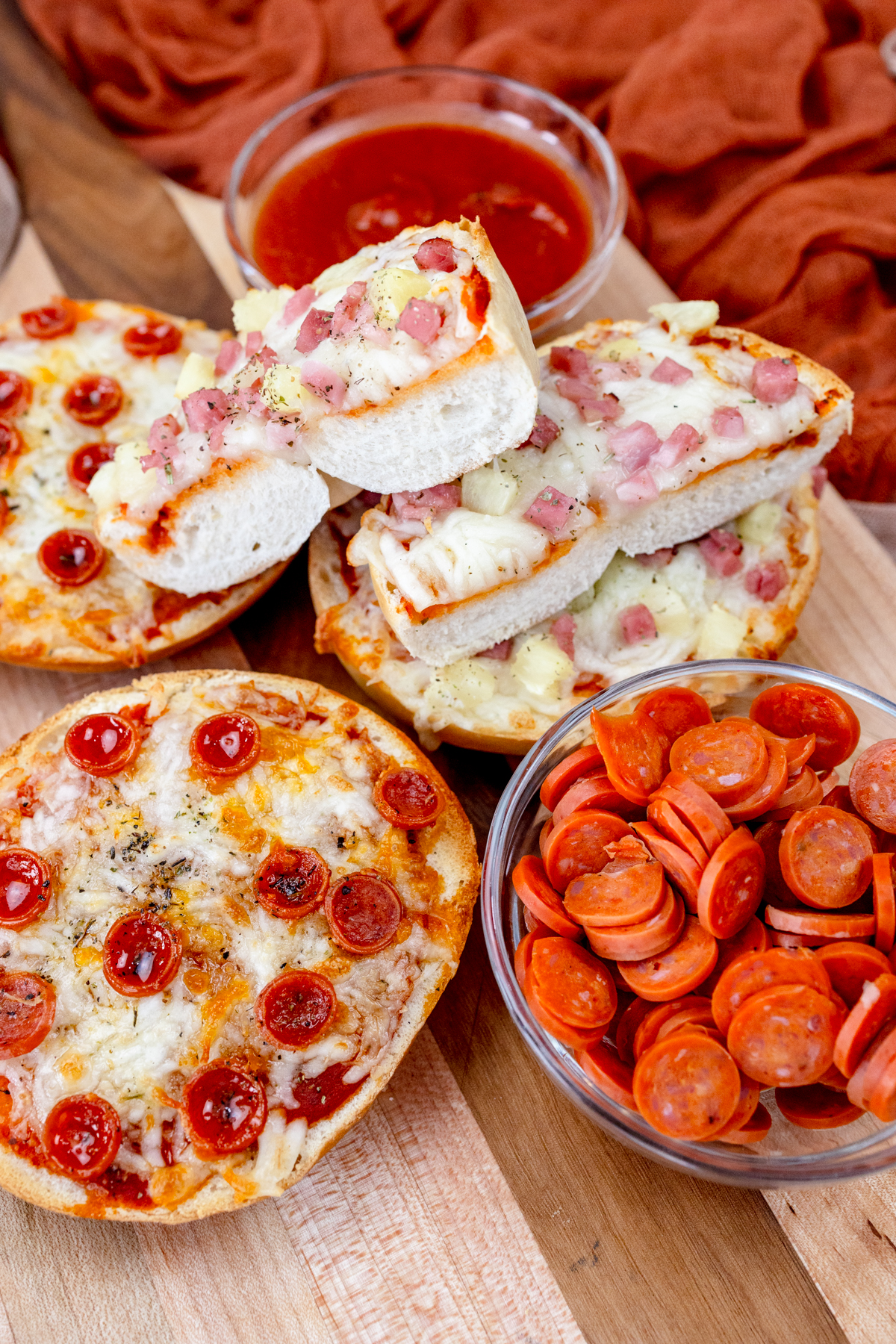 Close up view of Air Fryer Pizza Bagels on a wooden surface.