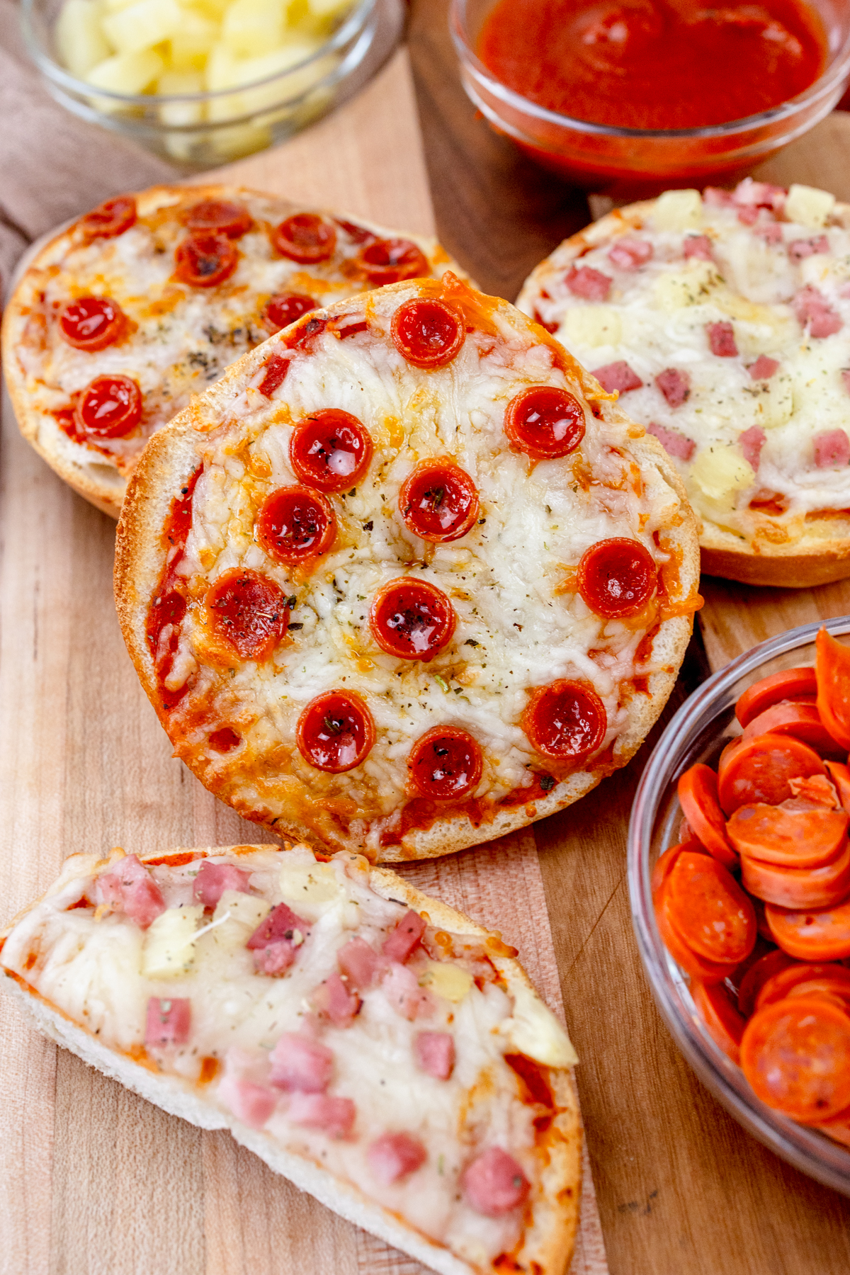 Close up view of Air Fryer Pizza Bagels on a wooden surface.