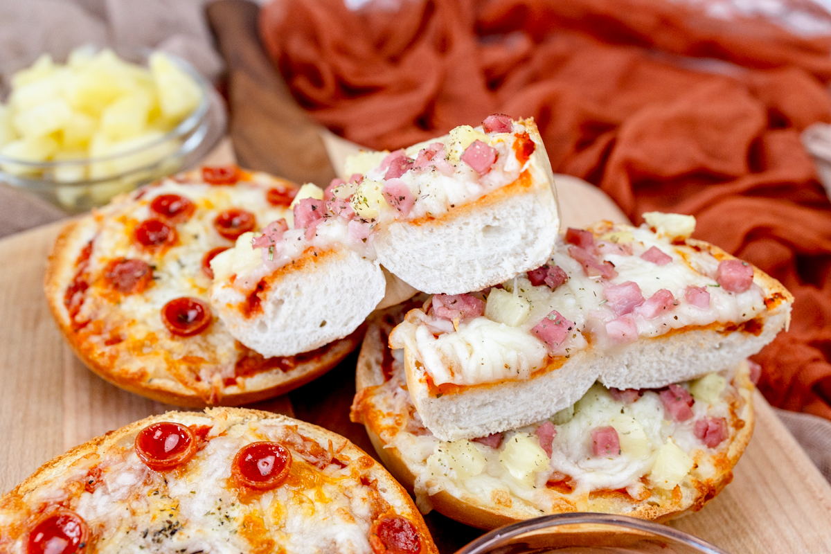 Close up view of Air Fryer Pizza Bagels on a wooden surface.