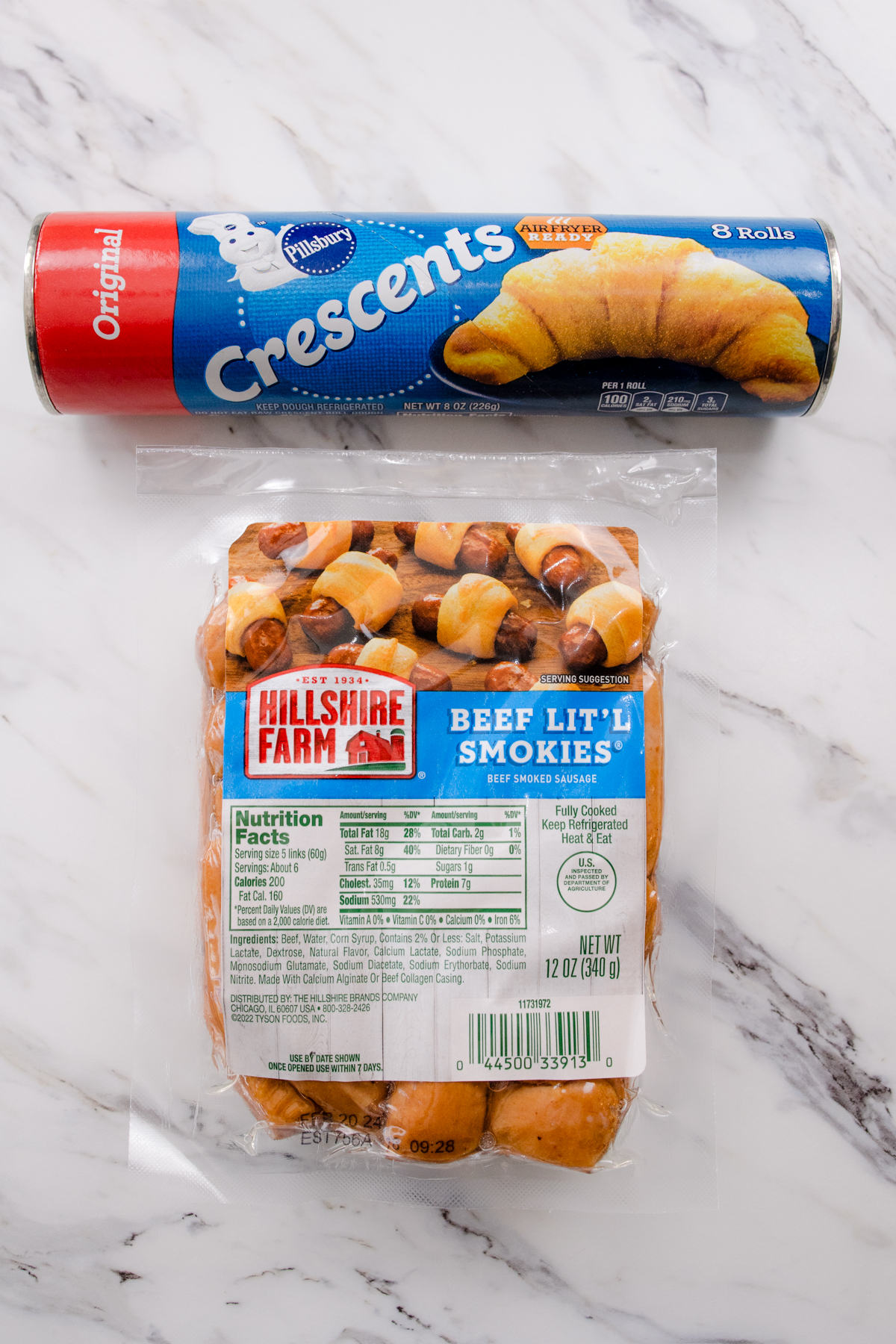 Top view of ingredients needed to make Air Fryer Pigs in a Blanket on a marble surface.