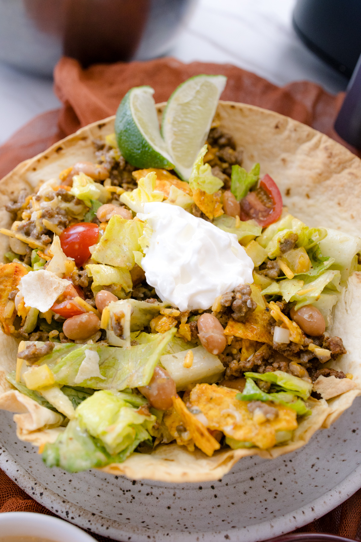 Air Fryer Flour Tortilla Bowl filled with tortilla fillings, on a plate.