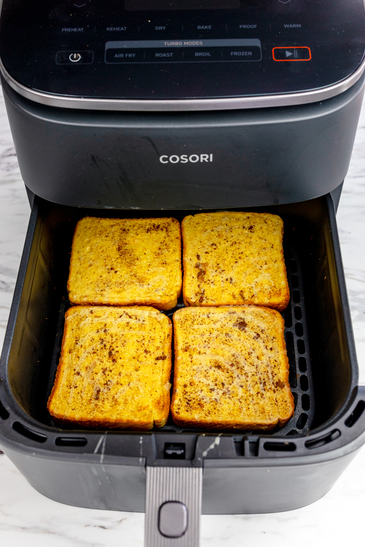 An air fryer basket with Air Fryer French Toast in it.