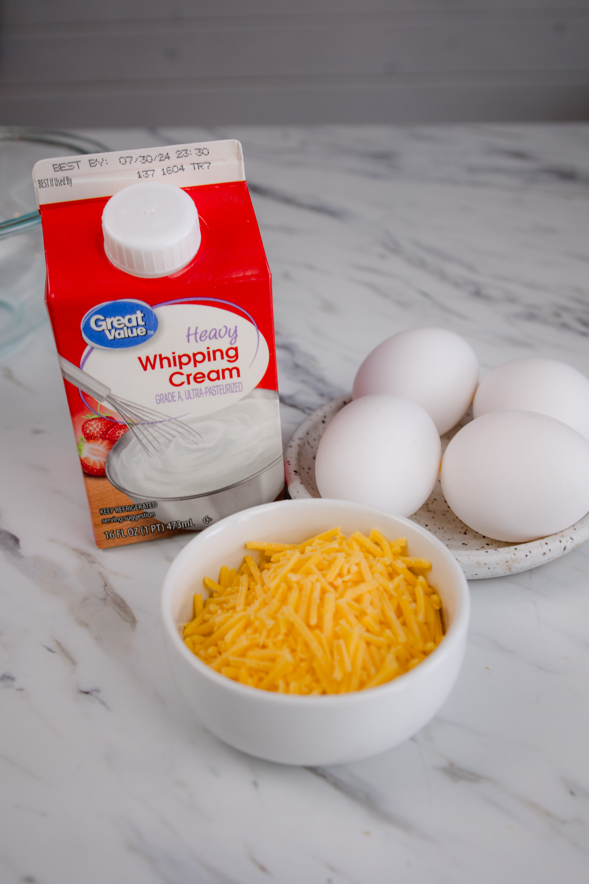 A close up image of the ingredients needed to make Air Fryer Scrambled Eggs.