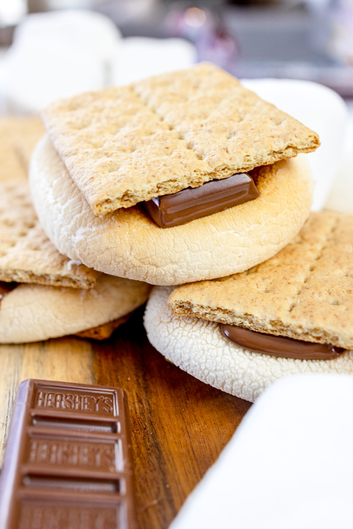 Air Fryer Smores stacked up on a wooden surface.