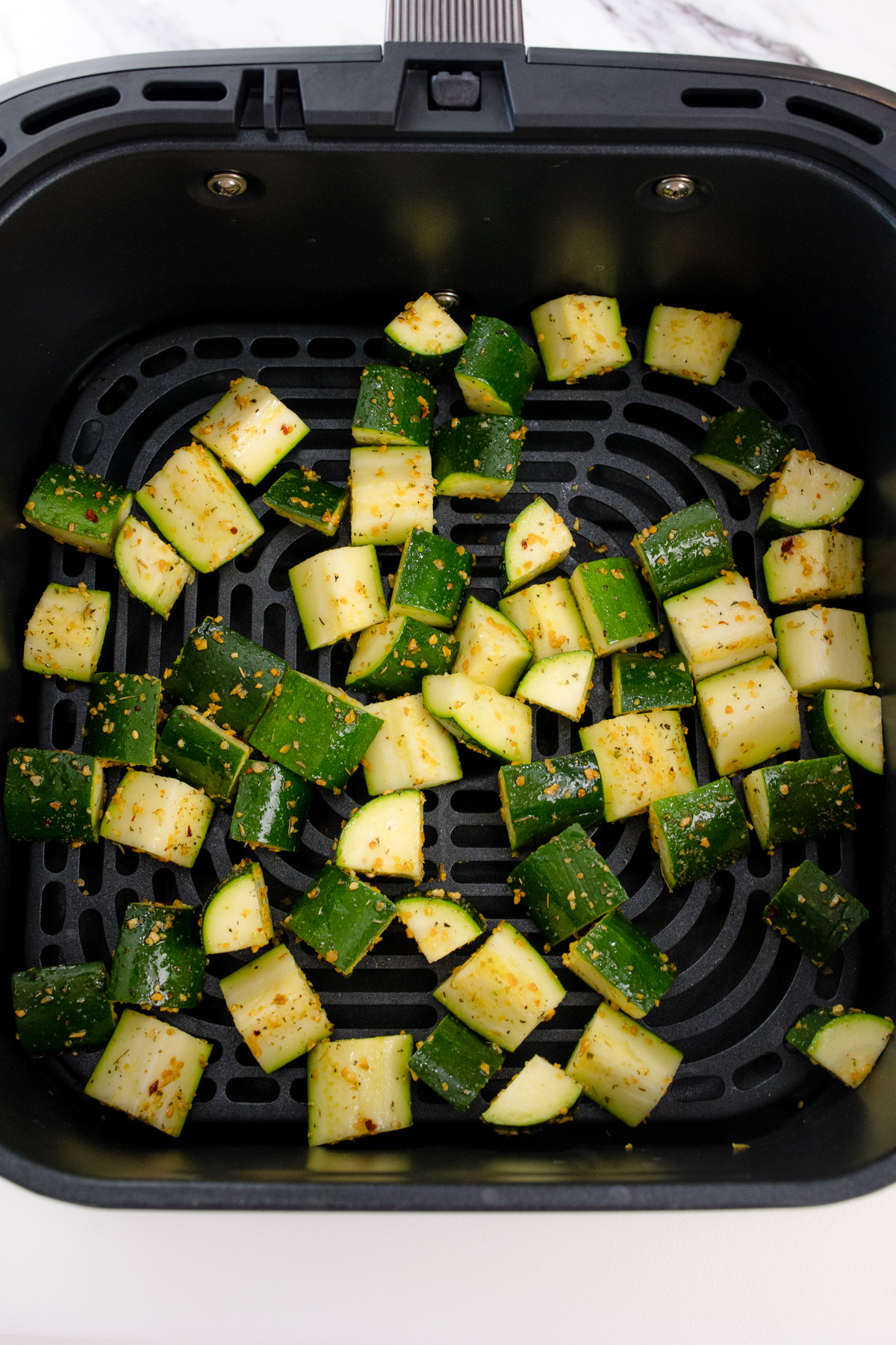 Chopped zucchini in air fryer.