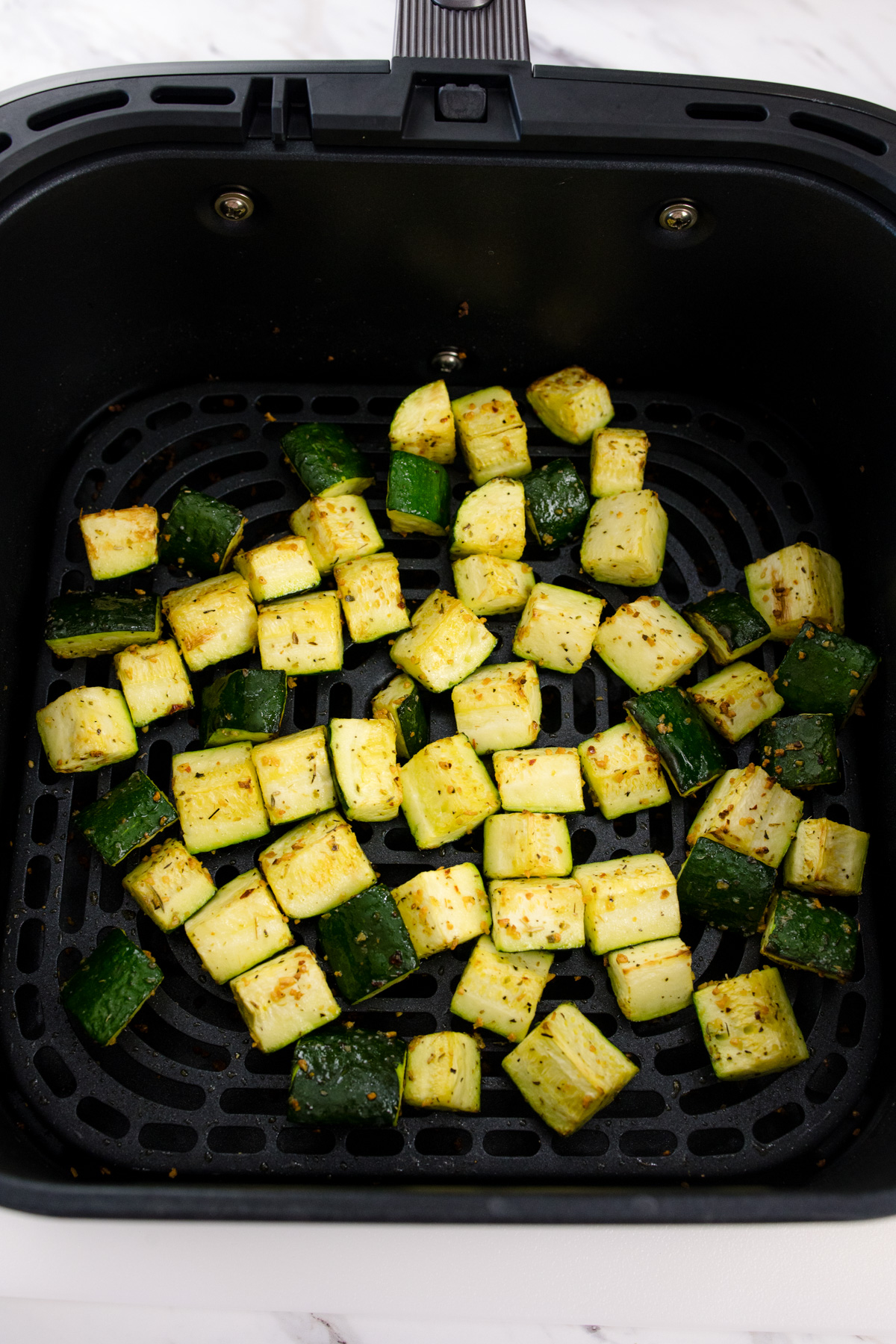 Chopped zucchini in air fryer.