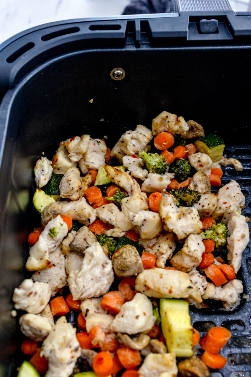 Air Fryer Chicken and Vegetables in an air fryer basket.