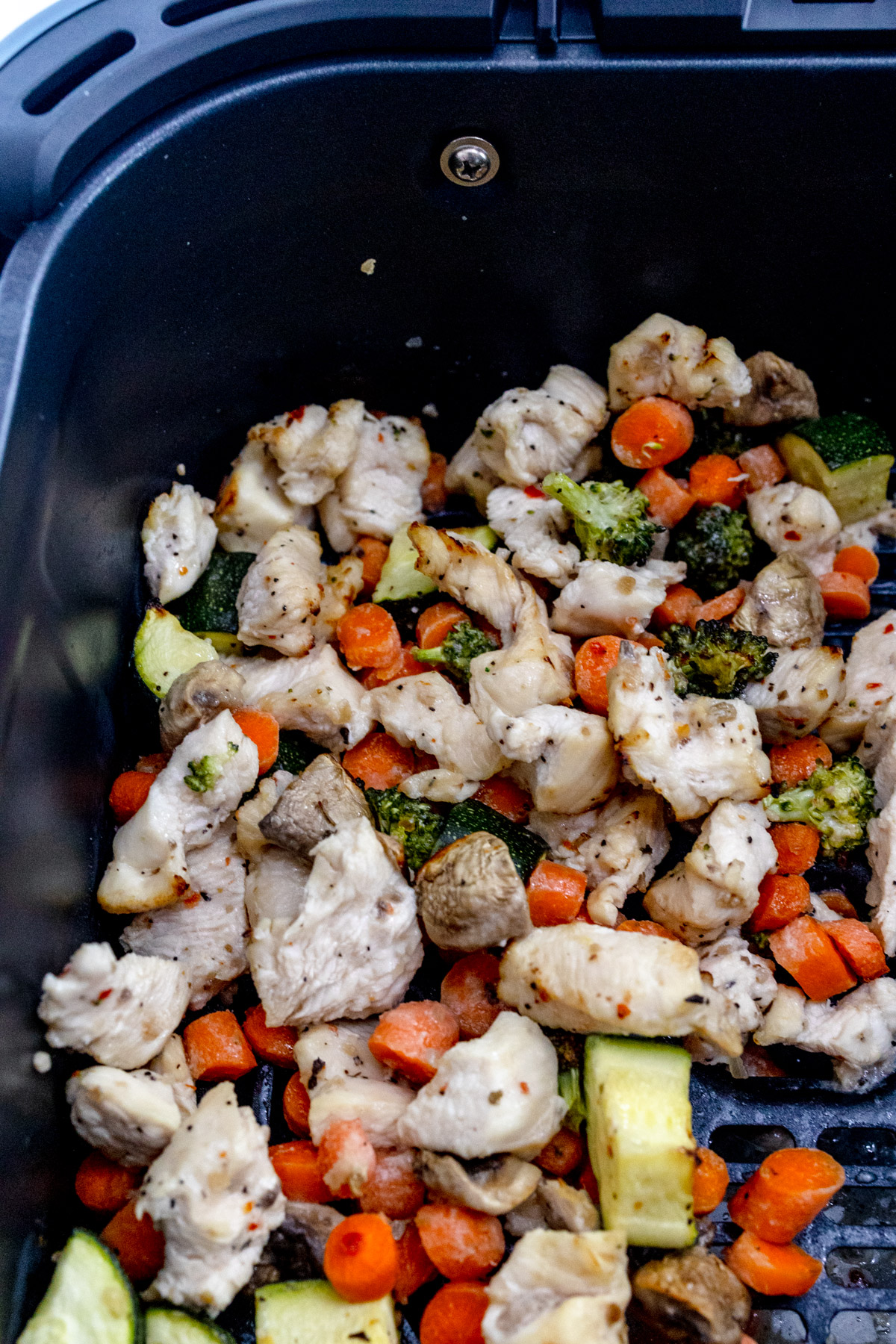 Air Fryer Chicken and Vegetables in an air fryer basket.